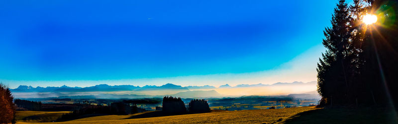 Panoramic view of landscape against clear blue sky