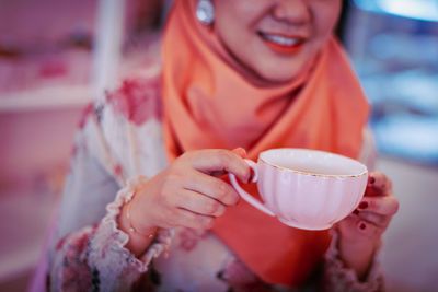 Midsection of woman holding ice cream