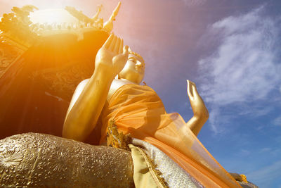 Low angle view of statue of buddha against sky