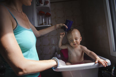 High angle view of woman washing hands in bathroom