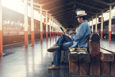 Man looking away while sitting on seat