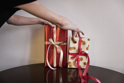 Person putting christmas presents on table