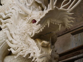 Low angle view of statue against white temple