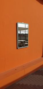 Close-up of window on orange wall