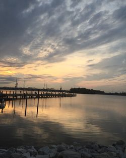 Pier over sea at sunset