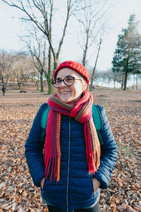 Portrait of smiling young woman standing on field