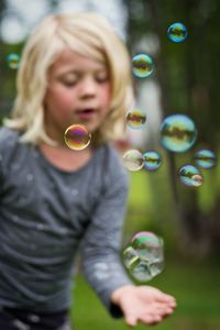 Close-up of girl playing with bubbles