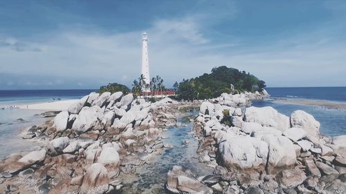 View of rocks on beach against sky