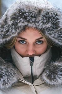 Close up of girl wearing furry winter coat.