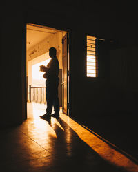 Silhouette man standing in corridor of building