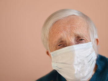  female senior patient wearing medical protective mask. visiting clinic. healthcare and medicine. 