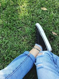 Low section of woman sitting on grass