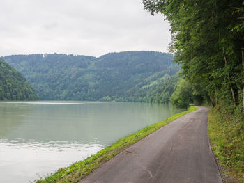 Road by lake against sky