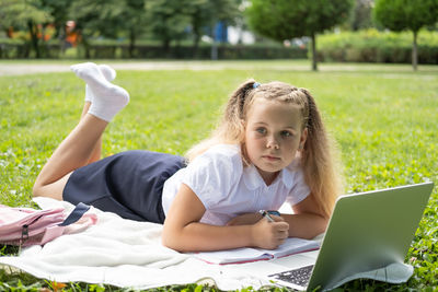 Young woman using laptop at park