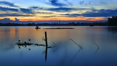 Scenic view of lake against sky at sunset