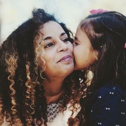 Close-up of cute girl kissing mother