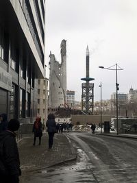 People in city against clear sky