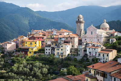 Buildings in city against mountains