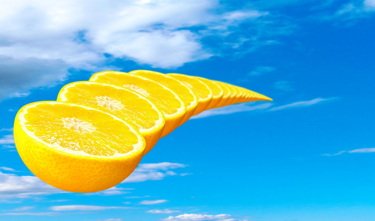 LOW ANGLE VIEW OF ORANGE AGAINST BLUE SKY