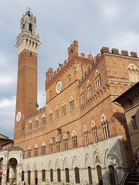 Low angle view of clock tower against sky