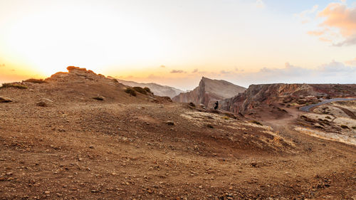 Scenic view of desert against sky during sunset