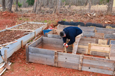 Rear view of man working at farm