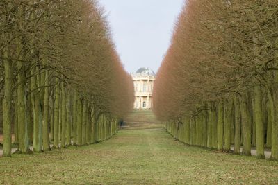 Footpath amidst buildings against sky