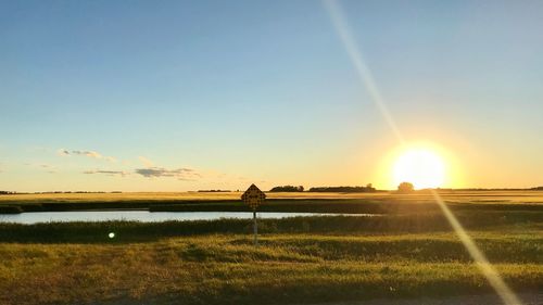 Scenic view of field against sky during sunset