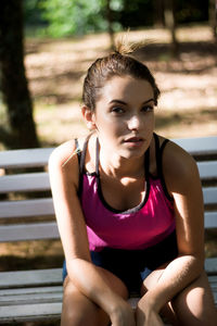 Portrait of a young woman sitting on bench