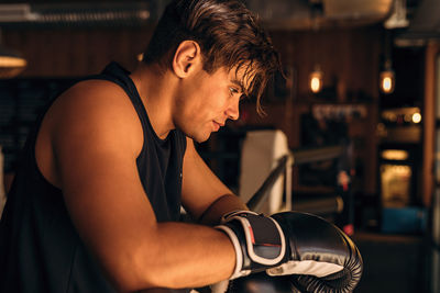 Thoughtful man with boxing gloves 