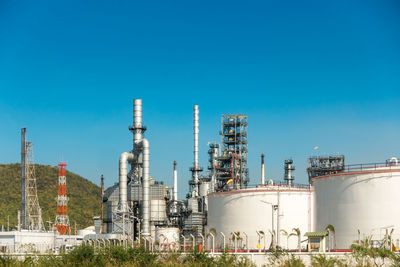 Low angle view of factory against blue sky