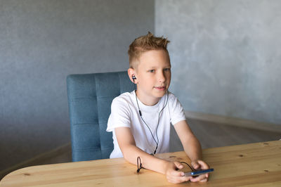 Portrait of boy playing with toy blocks at home