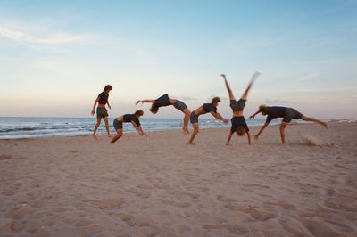 People on beach against sky