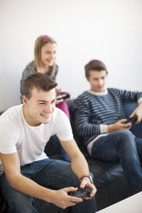 Children on sofa playing video game