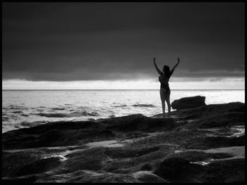 Rear view of man standing at beach