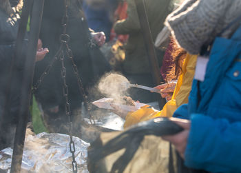 People holding fish for sale at market