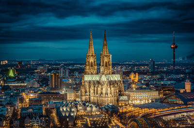 Aerial view of illuminated buildings in city at dusk