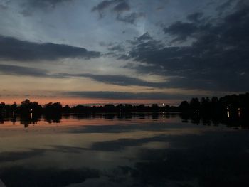 Scenic view of lake against sky at sunset