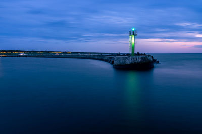 Stone pier in darlowo in the evening. traffic lights in the port. 