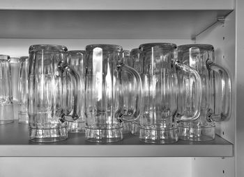 Jugs arranged on shelf in kitchen