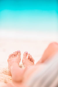 Low section of person resting on beach