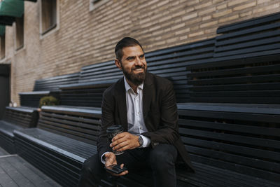 Smiling businessman looking away