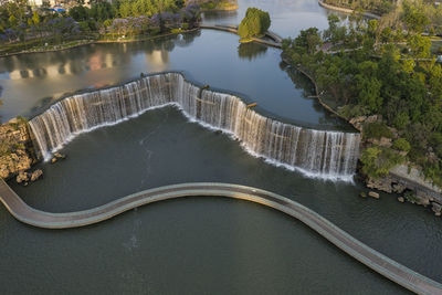 Aerial 360 degree view of the kunming waterfall park at sunset