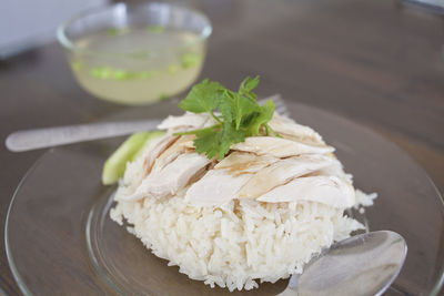 Close-up of rice with chicken in plate on table