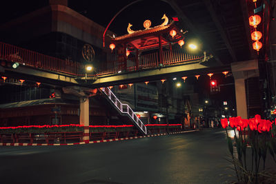 Illuminated bridge over city at night