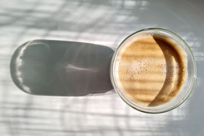 Top view of hot coffee under morning sunlight
