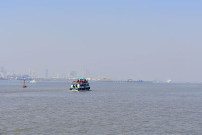 Ship sailing on sea against clear sky