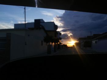 Silhouette buildings against sky during sunset