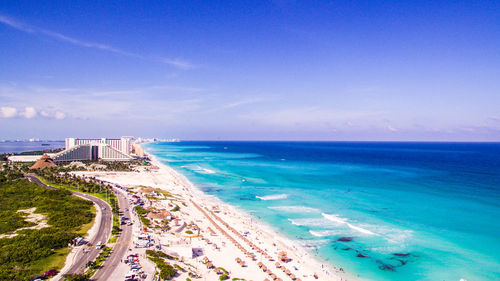 Scenic view of beach against blue sky