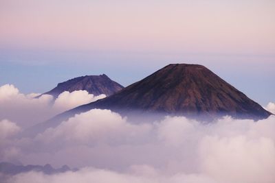 Scenic view of mountains against cloudy sky